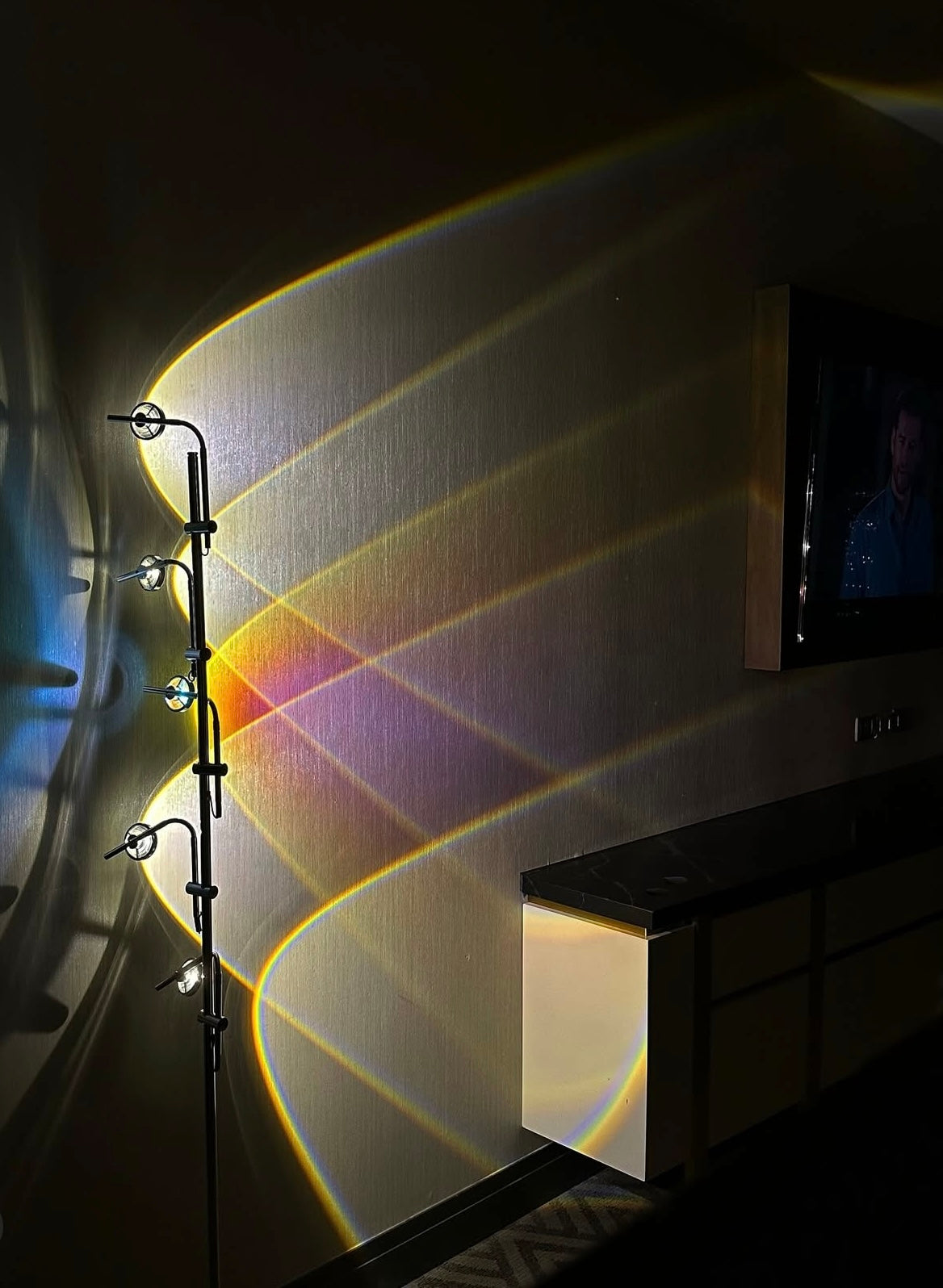 Polynescence Floor Lamp casting warm glow over minimalist living room sofa