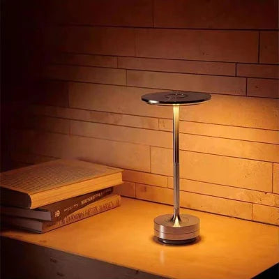 Aura Table Lamp on bedside nightstand in cozy bedroom with warm glow