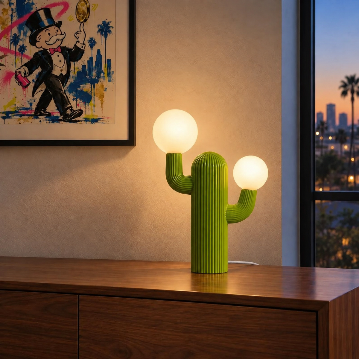 Prickly green cactus table lamp illuminated with a white woven fabric cord beside an evening city view.