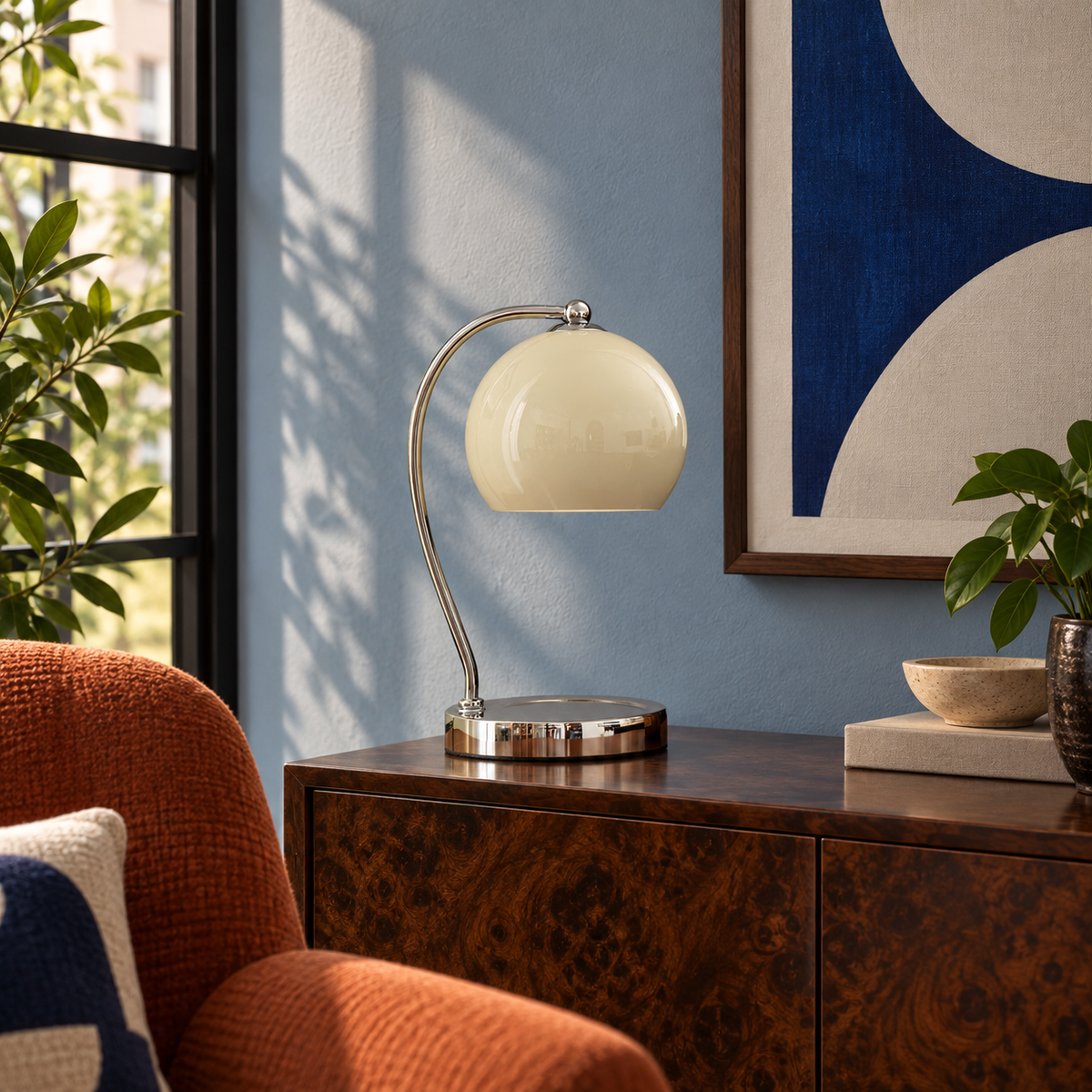Wick table lamp in a powder-blue room with russet seating and graphic art.