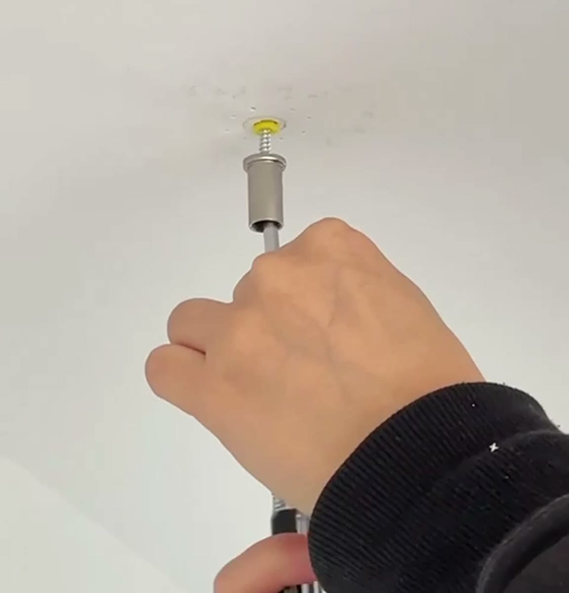 Driving the screw through the hollow ceiling fitting
