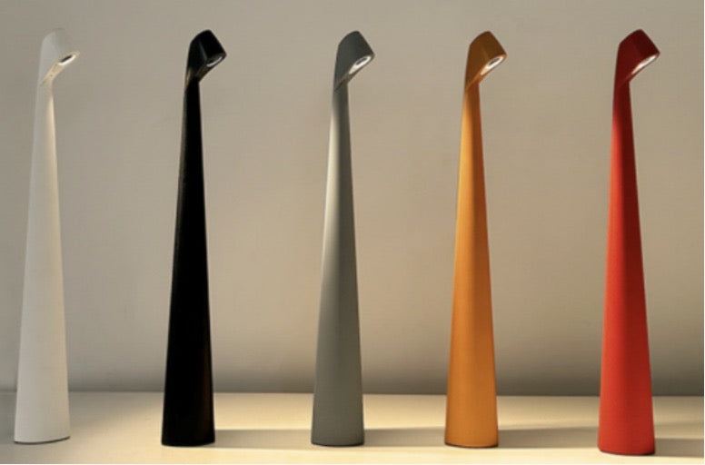 Flare Cordless Table Lamp in white illuminated with warm ambient glow
