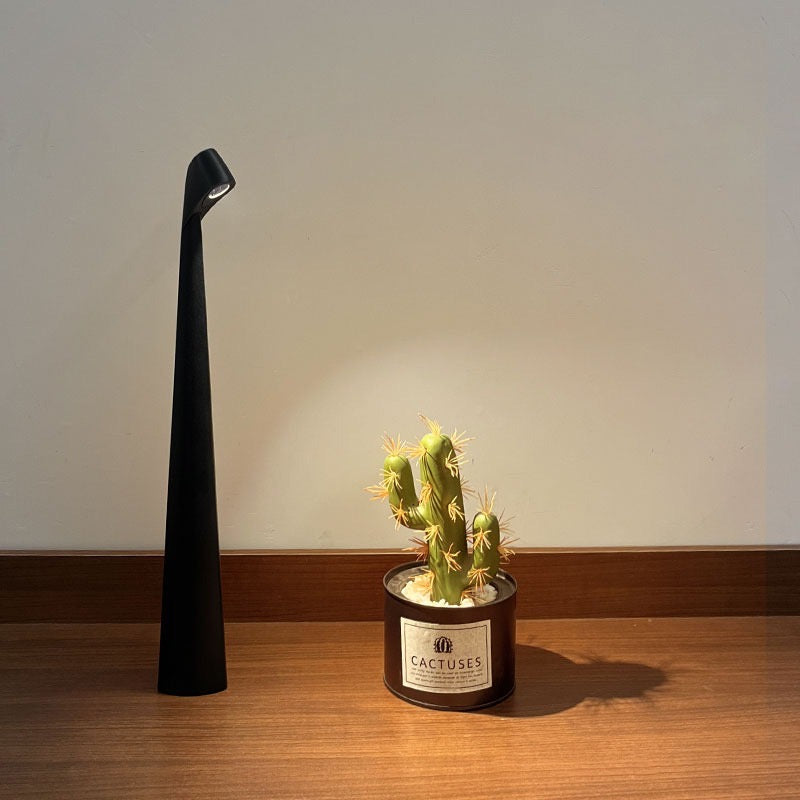 Flare Cordless Table Lamp in black matte finish with sculptural form lit