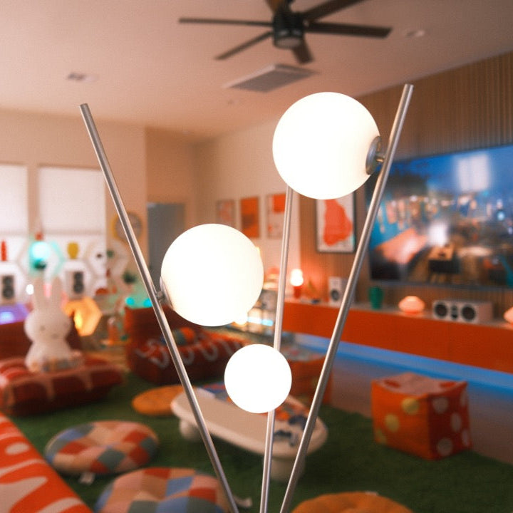 Triglobe Floor Lamp silver in modern living room with warm globe lighting
