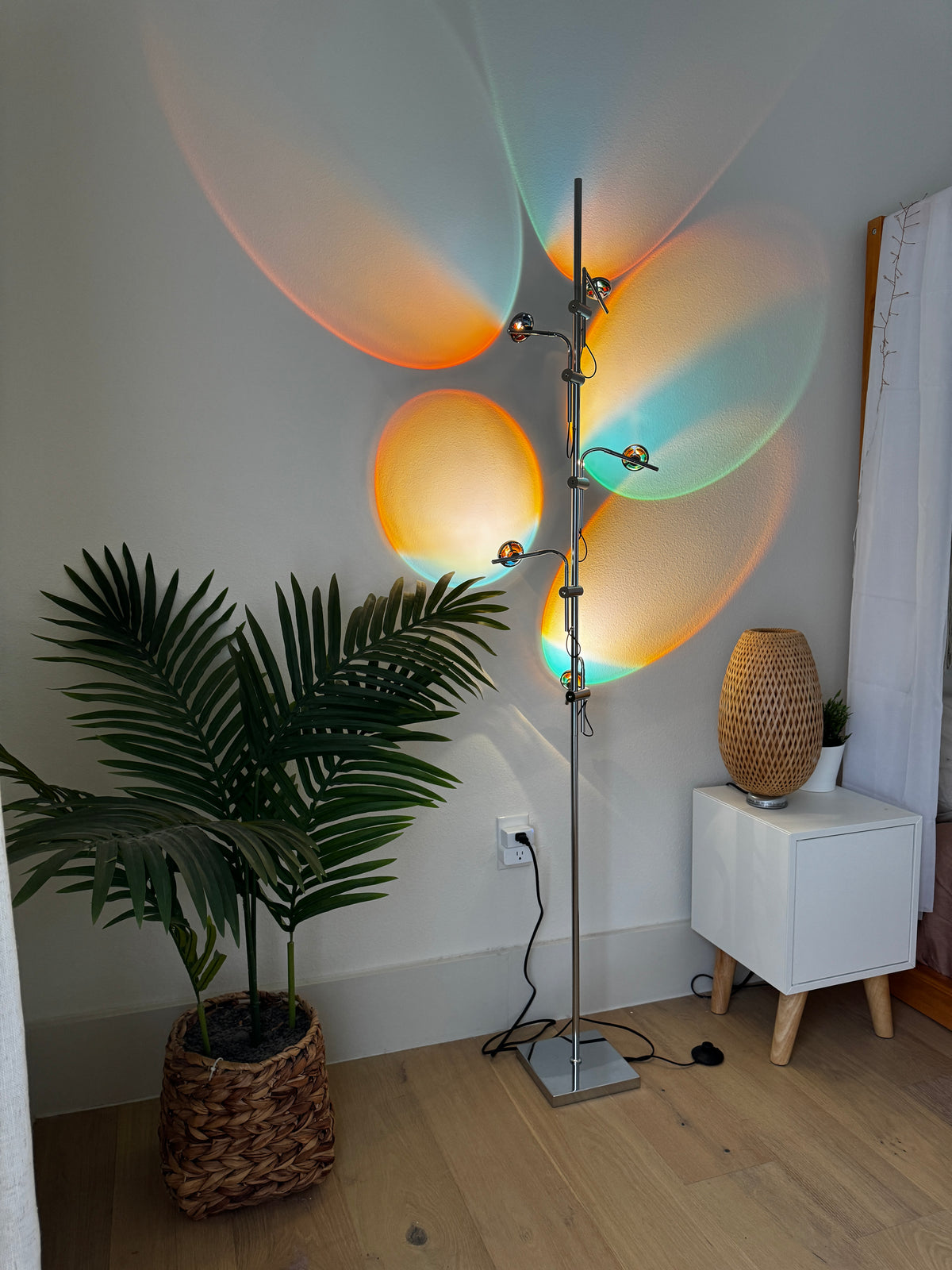 Polynescence Floor Lamp in bedroom setting beside reading chair