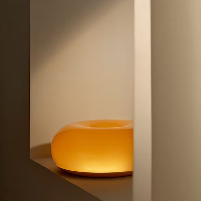 Glownut Lamp orange on decorative side table in modern living room