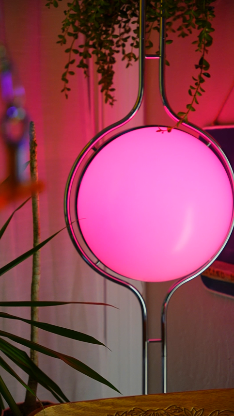 Pluto Floor To Ceiling Lamp installed in neutral-toned minimalist room