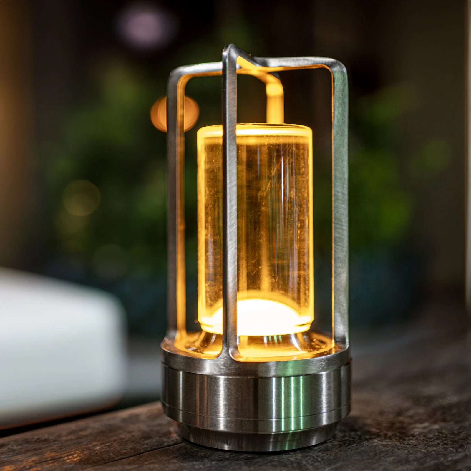 Lumina Lantern Table Lamp in dimly lit room casting warm prismatic patterns