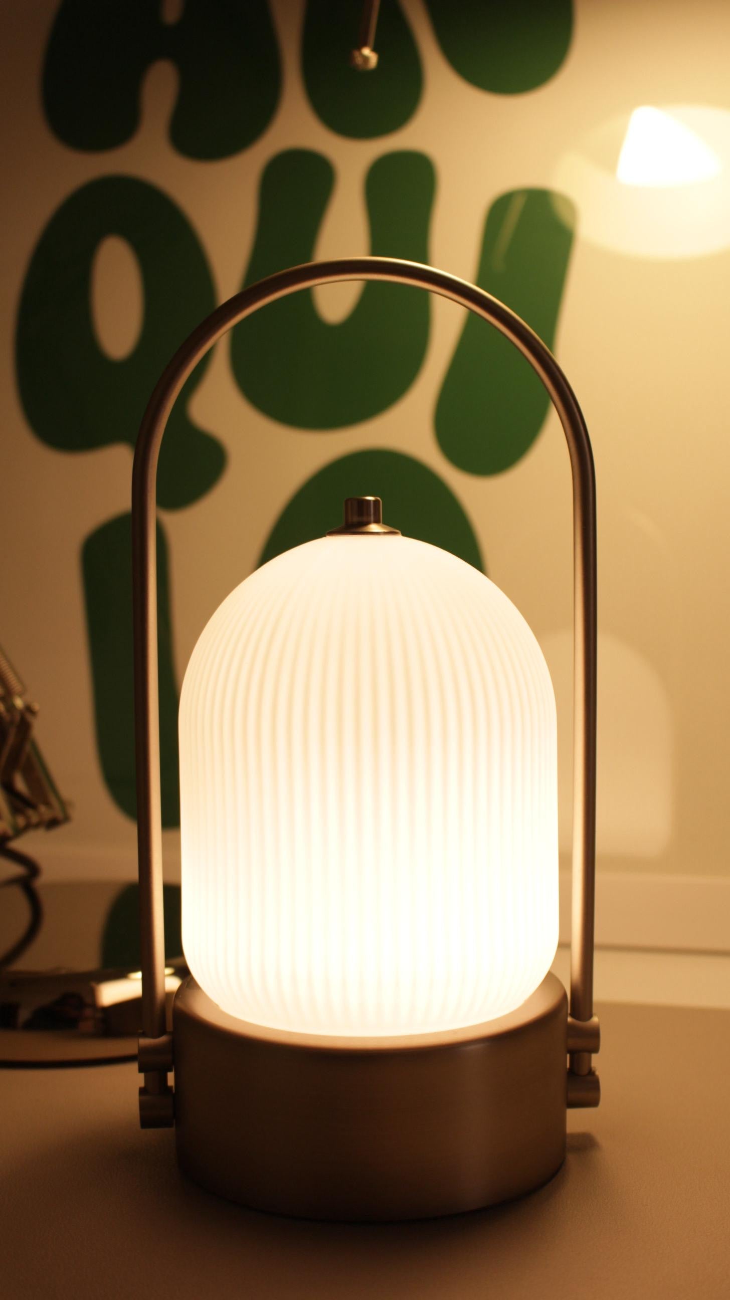 Kana Lamp close-up showing smooth tapered body and metallic finish