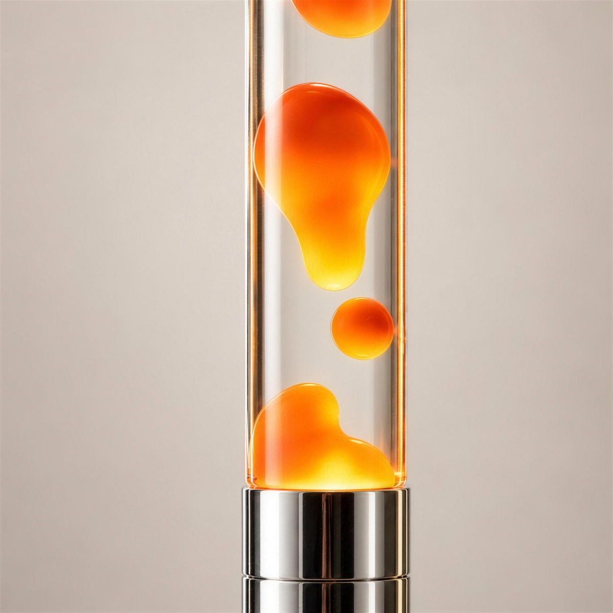 Close-up of glowing orange wax in the Molten Floor Lamp’s clear liquid, with polished silver detailing against a warm neutral background.