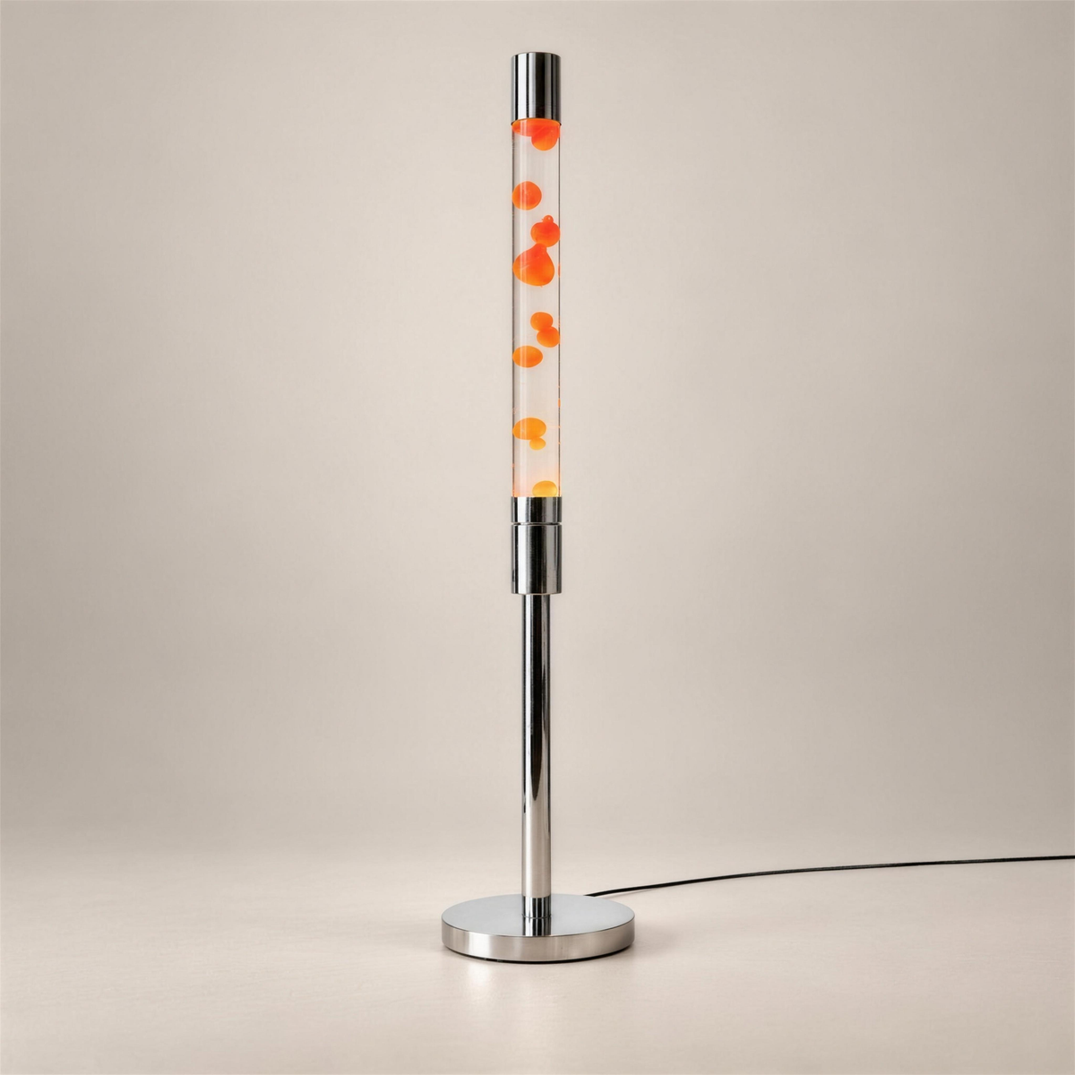 Molten Floor Lamp with polished silver detailing and orange wax in clear liquid, centered against a soft neutral background with a discreet black power cord.