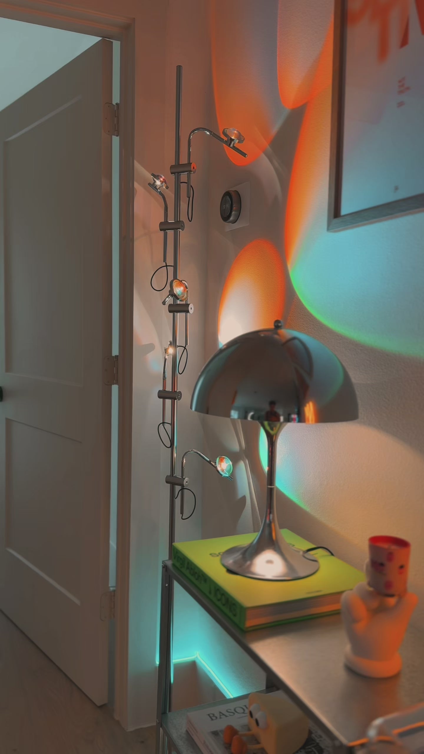 Video of Polynescence Floor Lamp demonstrating adjustable chrome arms and color filter lighting by La Caza Cali