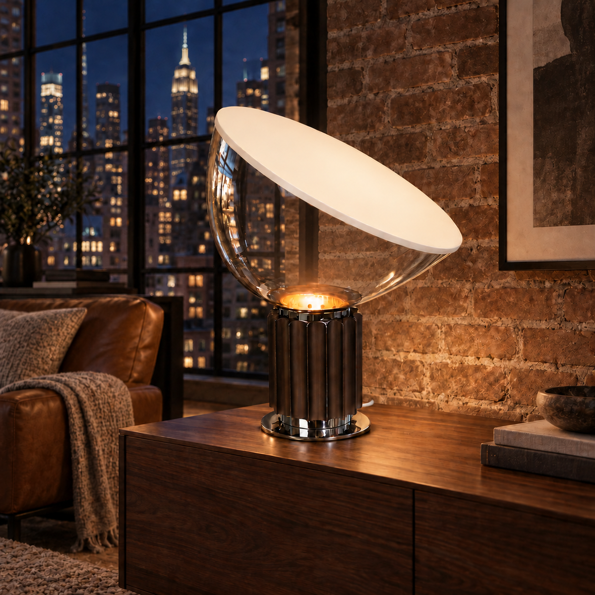 Projekt table lamp glowing in a New York loft at night, with a clear glass bowl and discreet white woven cord.