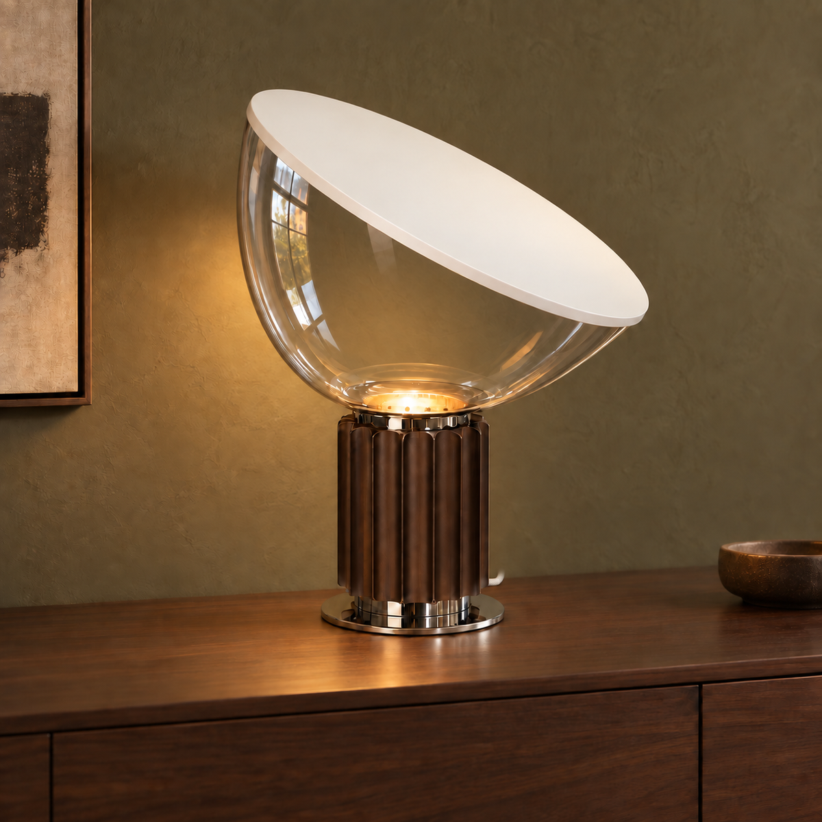 Projekt table lamp with a clear glass bowl and discreet white woven cord against an olive wall.
