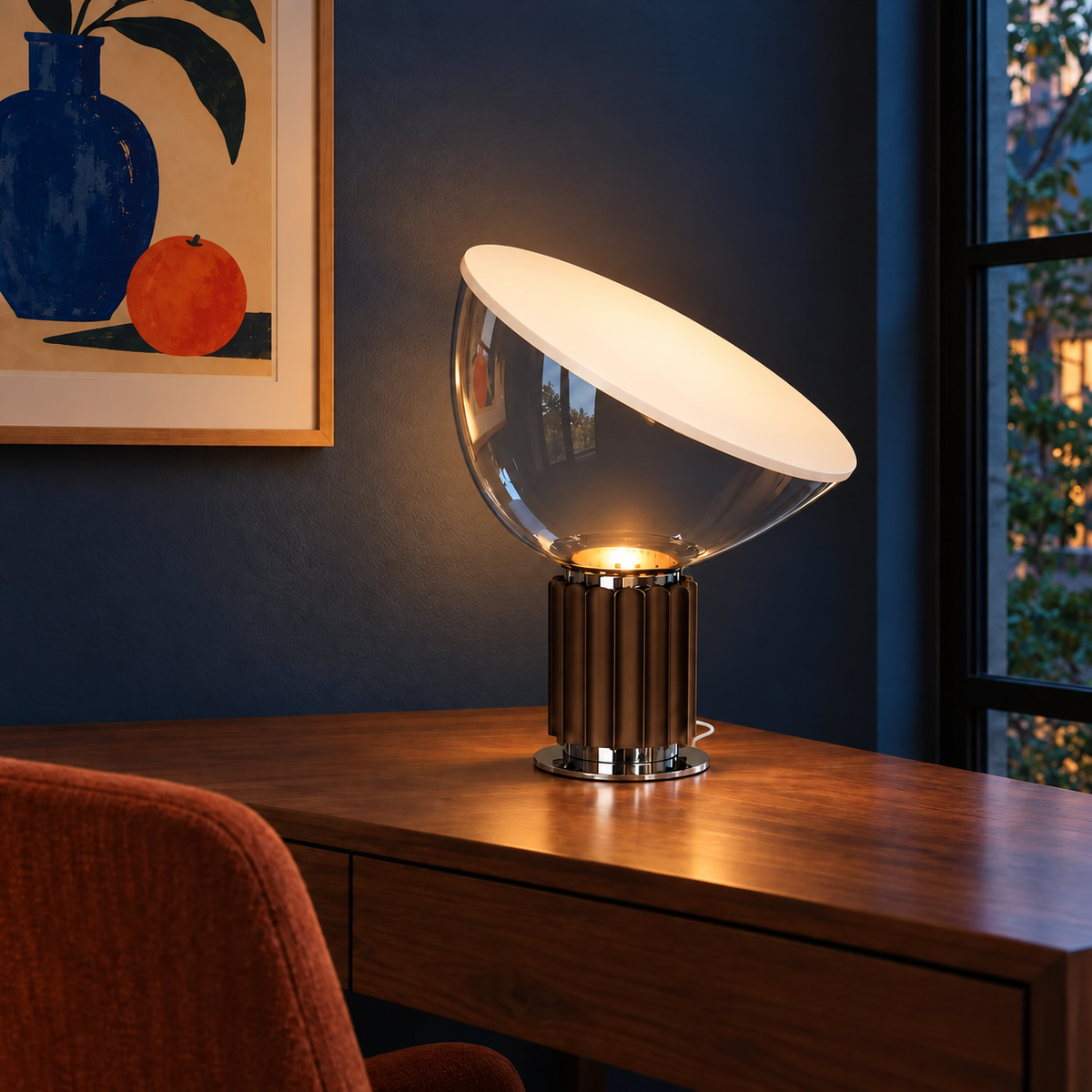 Projekt table lamp illuminated beside a dark blue wall, with a clear glass bowl and discreet white woven cord.