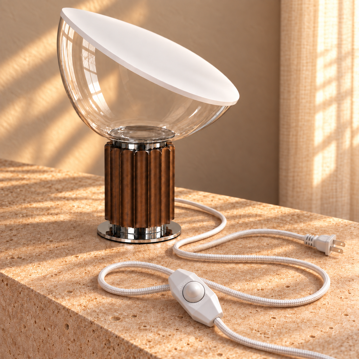 Projekt table lamp on travertine in golden-hour sunlight, showing the clear glass bowl, white woven cord, rotary dimmer and US plug.